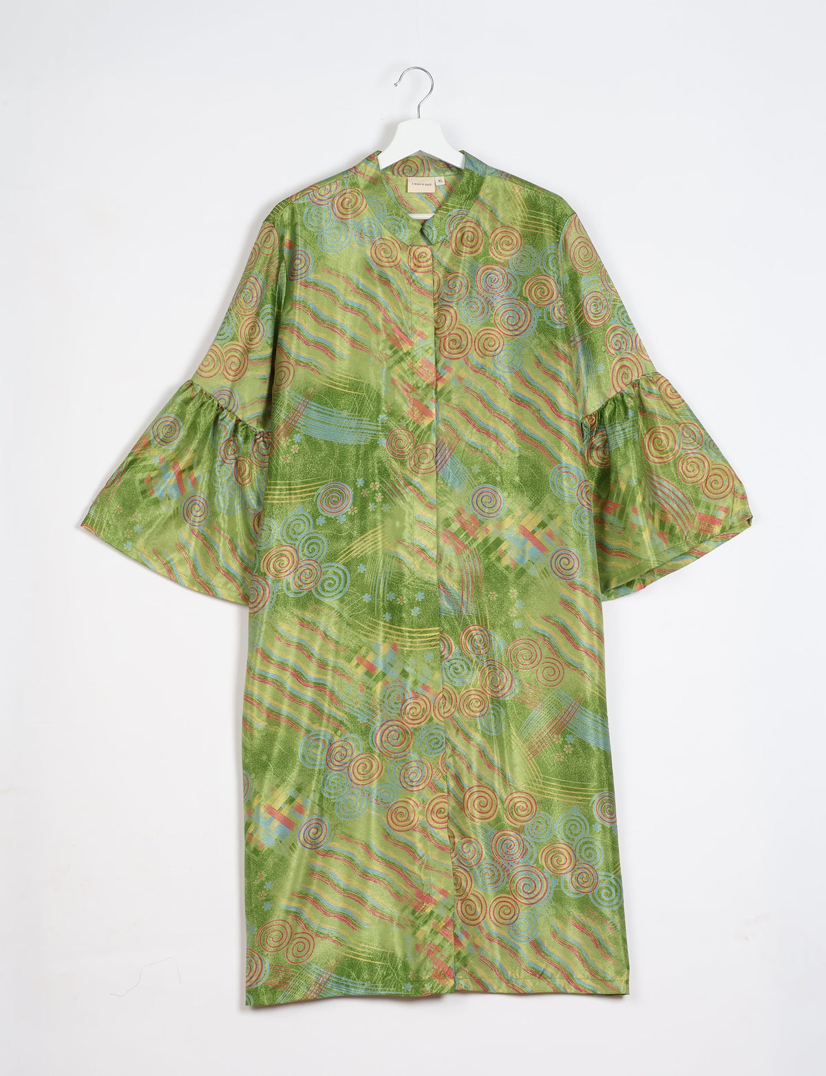 Green abstract patterned bell sleeve coat with round neckline hanging on white hanger front view