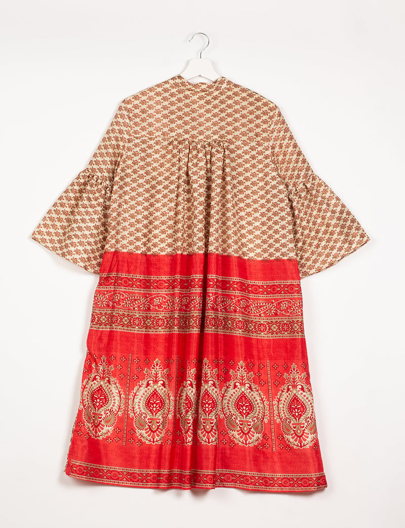 Beige and red bell sleeve coat with micro floral and ornate border patterns, shown from the back on a hanger