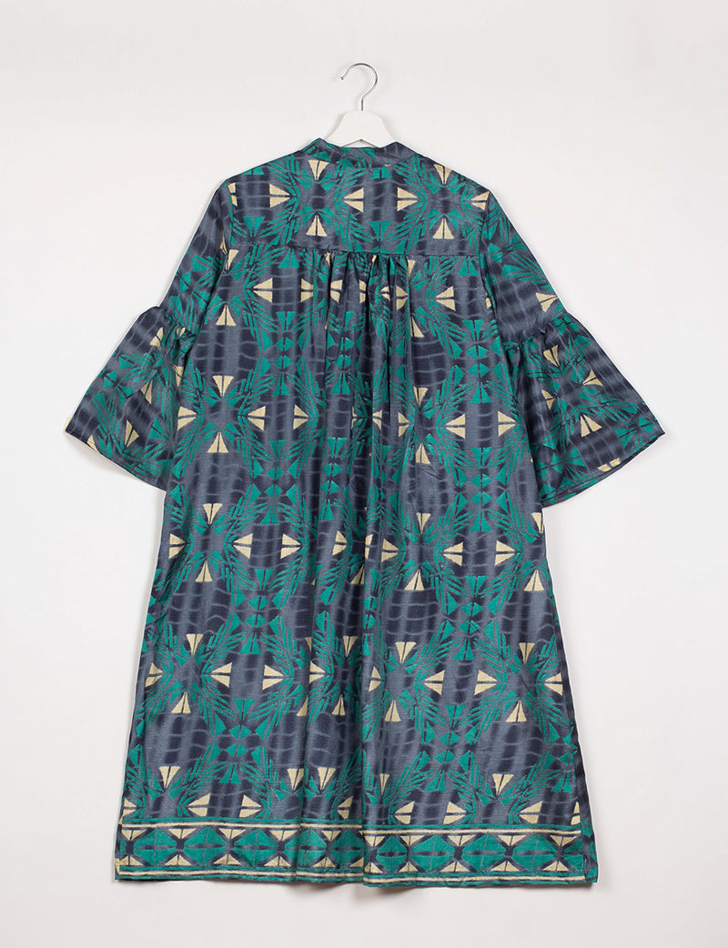 Blue geometric patterned bell sleeve coat hanging on white hanger, back view with gathered yoke and border print hem