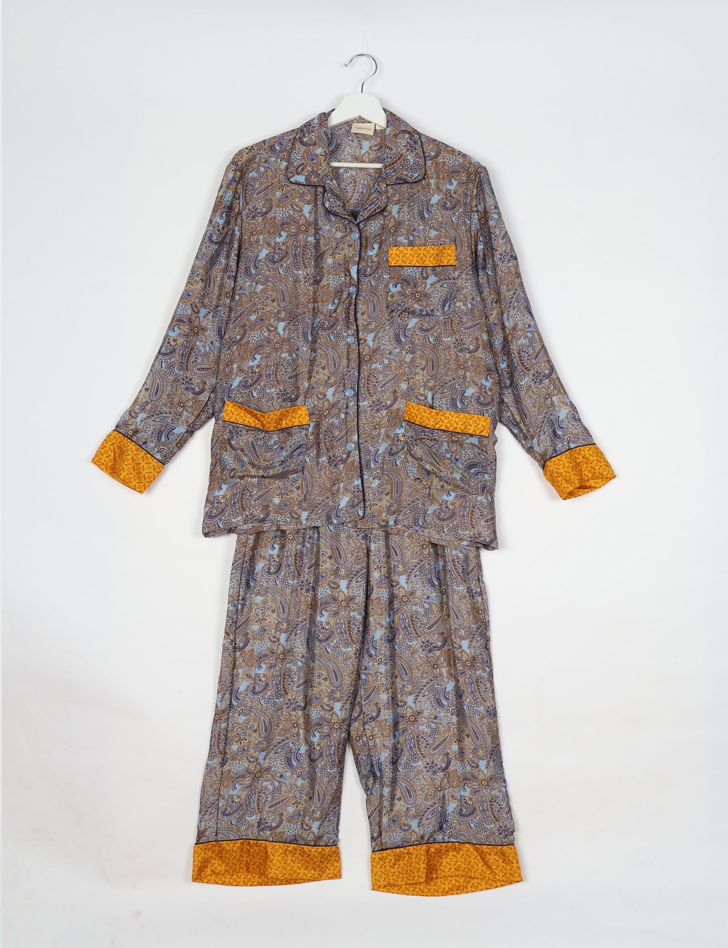 Chic long-sleeve pajama set made from recycled materials, representing eco friendly products, repurposed clothing, and zero waste clothing in green fashion.