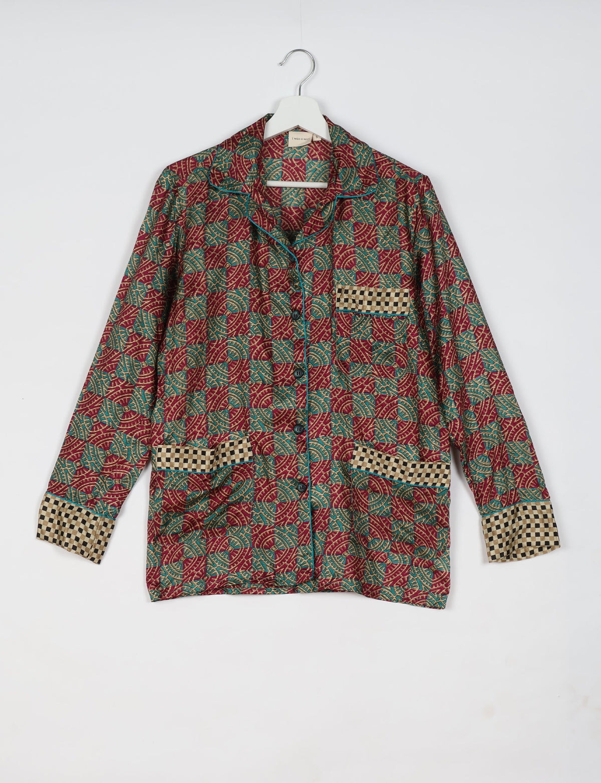 Long-sleeve red tropical print pajama top with checkered pocket and cuff details, button front, on white hanger