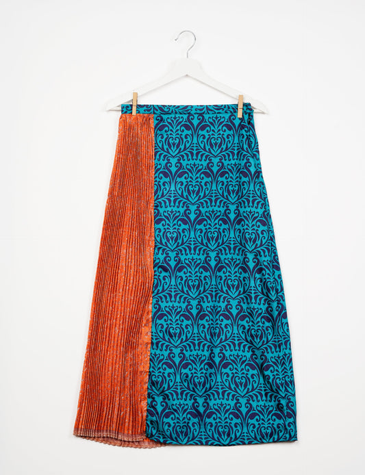 Elevate your wardrobe with the Semi Pleated A-Line Skirt, a sustainable fashion statement. Unique prints, a mix of fabrics, and intricate knife pleats create an individualized, upscale day-to-night look. Crafted with ethical and green fashion values, this skirt represents the essence of eco-friendly style.