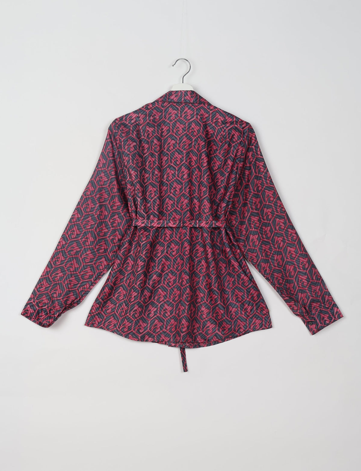 Pink and black Indian ethnic shirt with geometric pattern, long sleeves, and back tie detail, shown hanging from a hanger