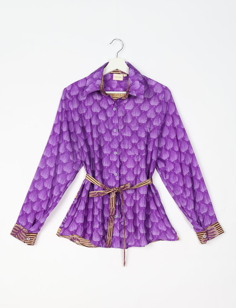 Purple button-up shirt with leaf pattern, long sleeves, collar, and patterned belt tied at waist, shown on hanger