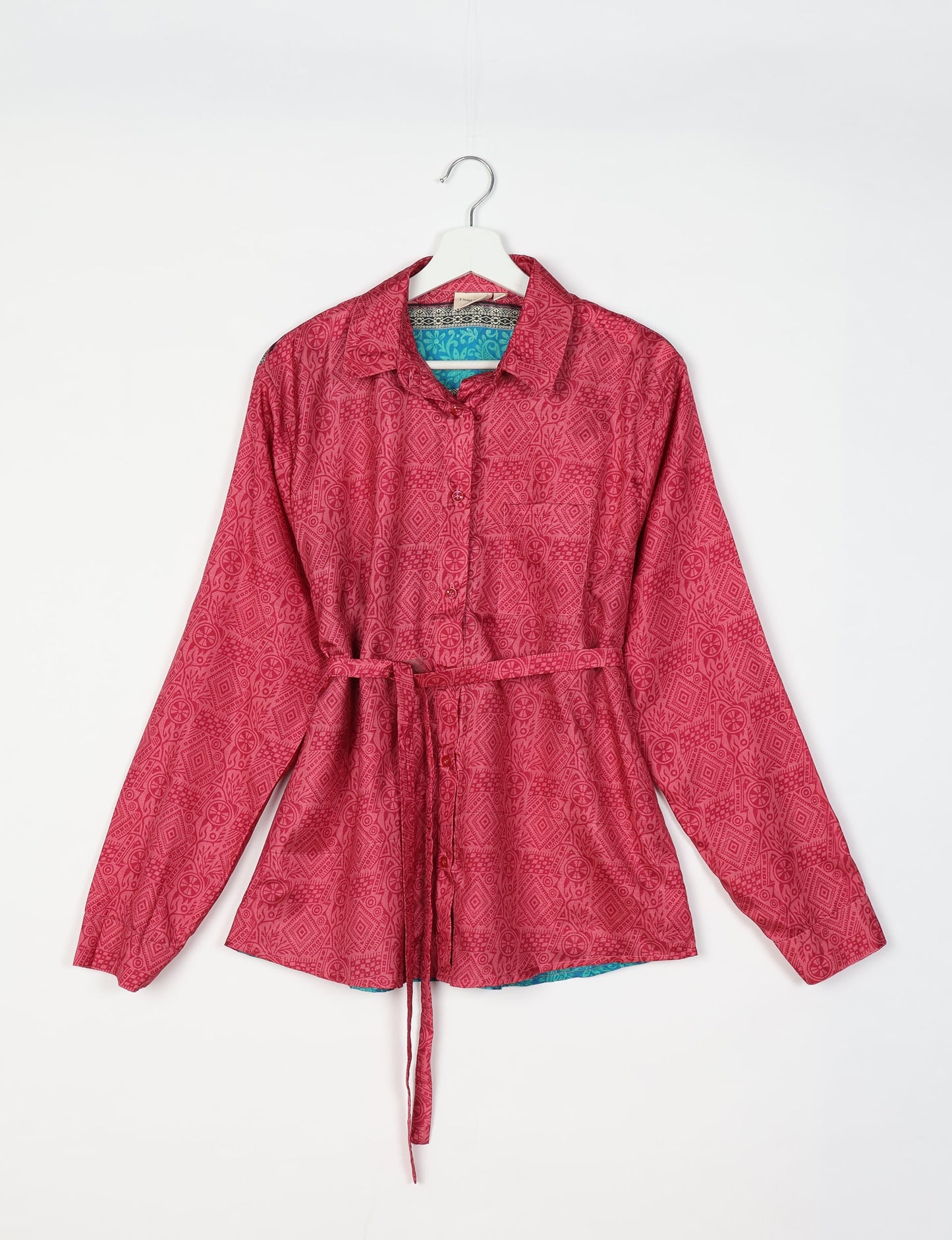 Experience sustainable fashion with our classic slim-fit shirt, crafted with ethical and green values. The shirt, designed for minimal waste, features a tie-up waist belt or neck tie, semi-spread collar, and regular shirt cuffs. Versatile and eco-friendly, wear it tucked in, unbuttoned over a tank top, or knotted at the waist for a unique style.