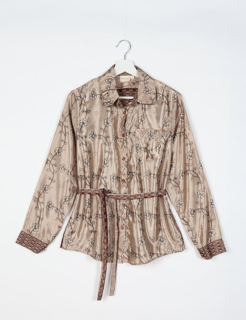 Beige floral long-sleeve shirt with button front, chest pocket, patterned cuffs, and matching fabric belt on hanger