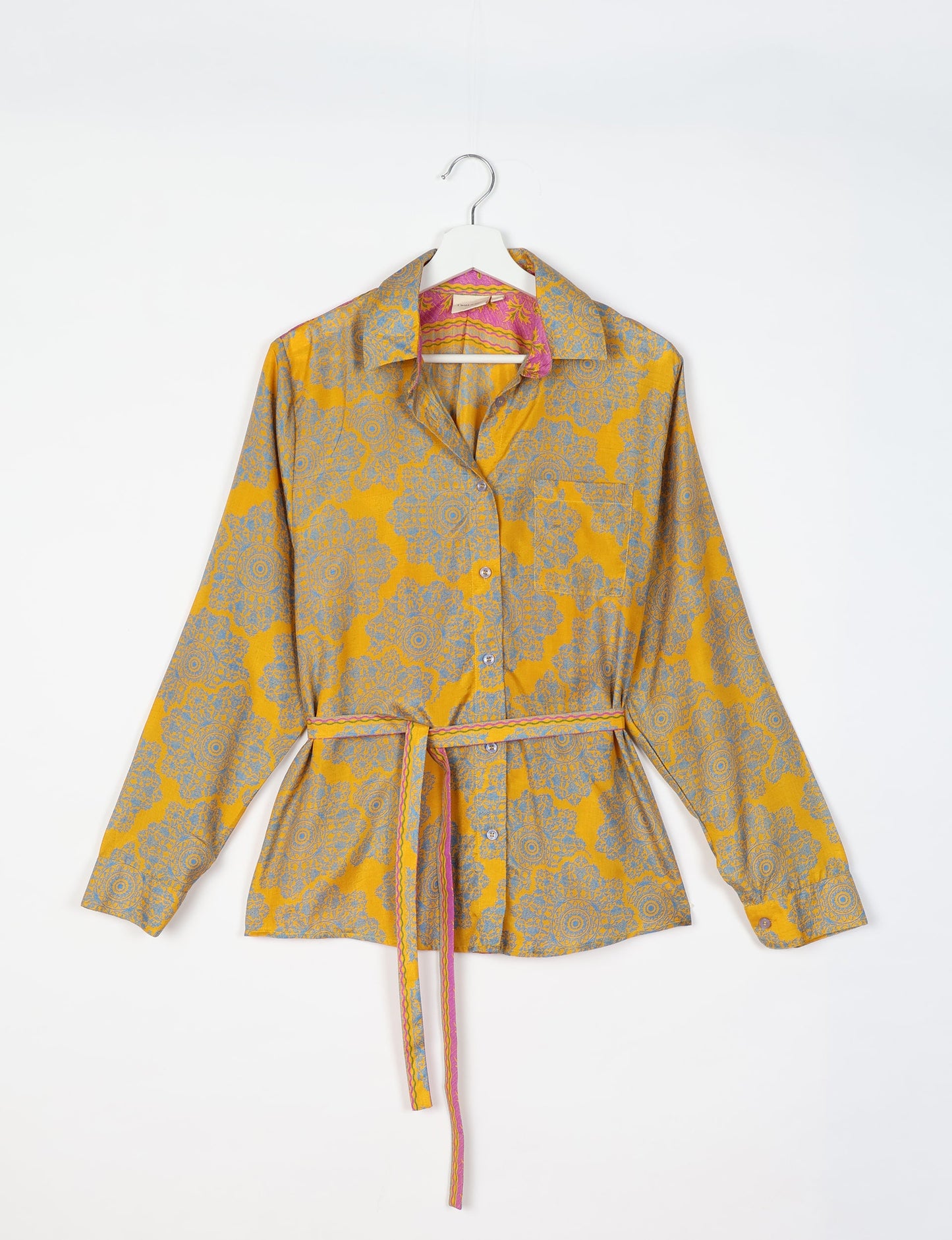 Experience sustainable fashion with our classic slim-fit shirt, crafted with ethical and green values. The shirt, designed for minimal waste, features a tie-up waist belt or neck tie, semi-spread collar, and regular shirt cuffs. Versatile and eco-friendly, wear it tucked in, unbuttoned over a tank top, or knotted at the waist for a unique style.