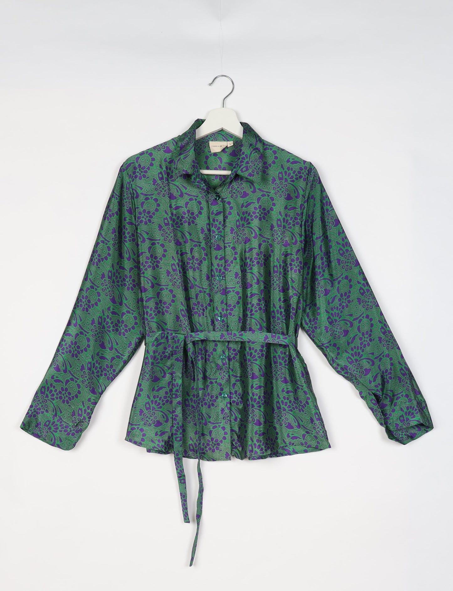 Experience sustainable fashion with our classic slim-fit shirt, crafted with ethical and green values. The shirt, designed for minimal waste, features a tie-up waist belt or neck tie, semi-spread collar, and regular shirt cuffs. Versatile and eco-friendly, wear it tucked in, unbuttoned over a tank top, or knotted at the waist for a unique style.