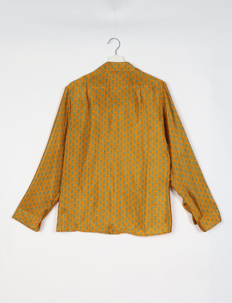 Yellow long-sleeve shirt with green micro floral pattern, buttoned cuffs, shown from back on white hanger against white background