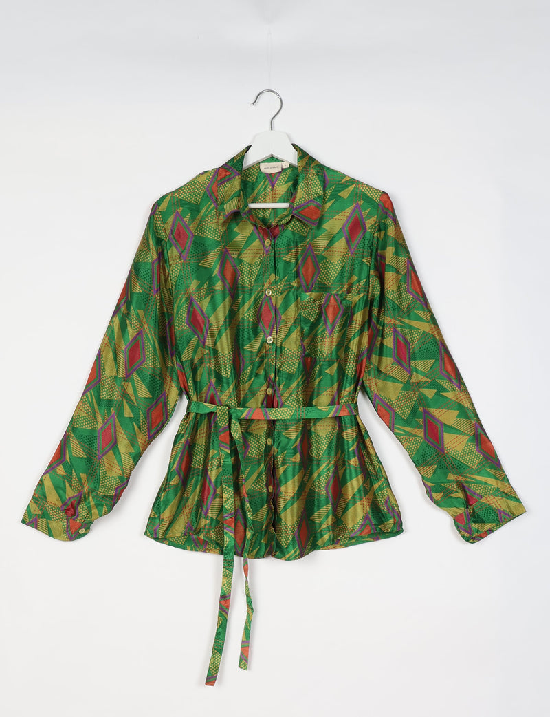 Green geometric patterned long-sleeve shirt with collar and front buttons, displayed on a hanger