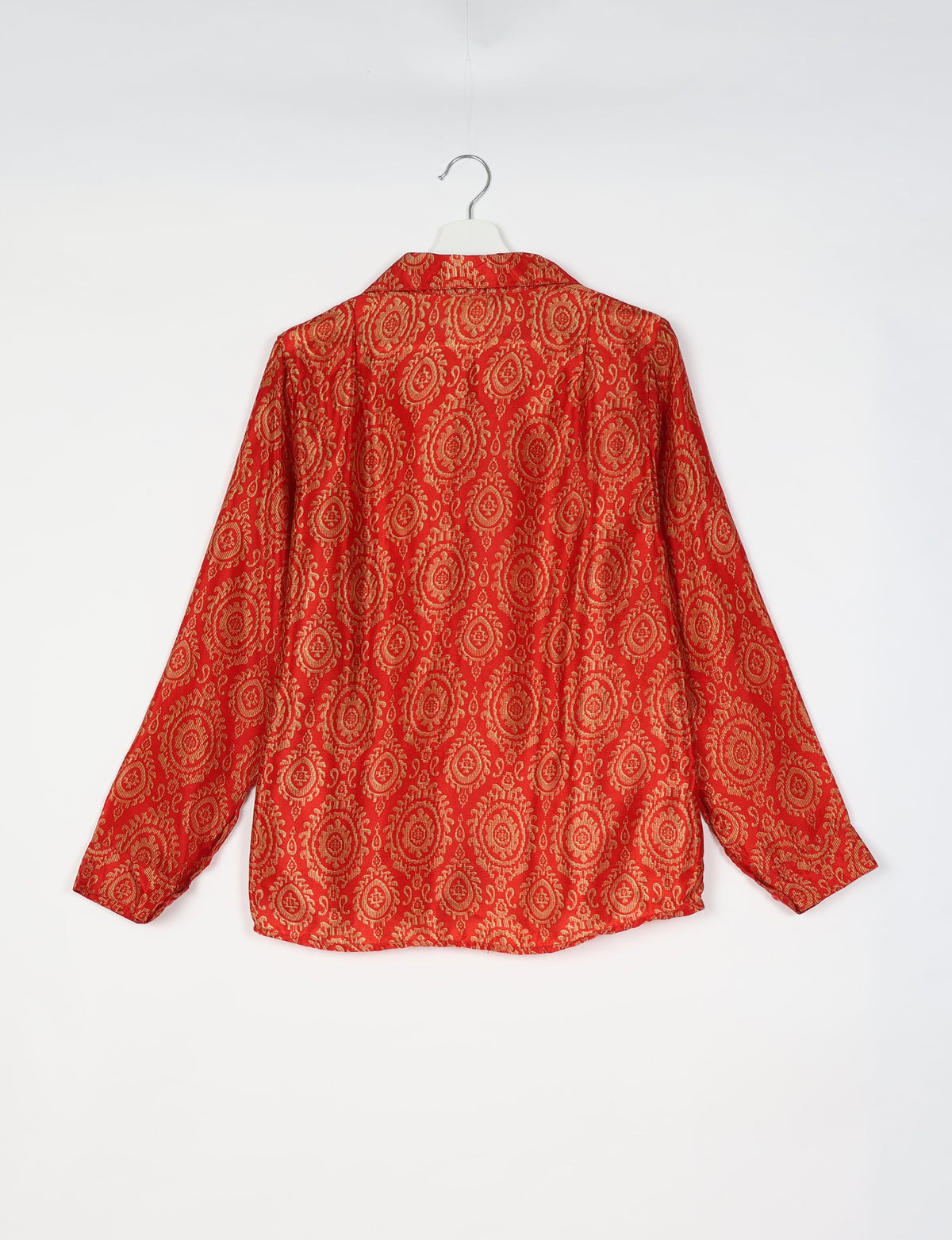 Orange ethnic shirt with gold circular floral pattern, long sleeves, and collar, shown from back on white hanger