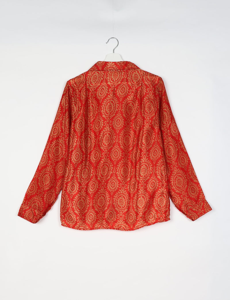 Orange ethnic shirt with gold circular floral pattern, long sleeves, and collar, shown from back on white hanger