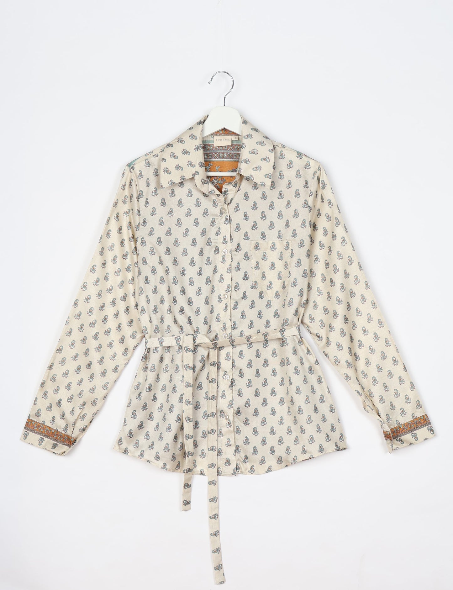 Experience sustainable fashion with our classic slim-fit shirt, crafted with ethical and green values. The shirt, designed for minimal waste, features a tie-up waist belt or neck tie, semi-spread collar, and regular shirt cuffs. Versatile and eco-friendly, wear it tucked in, unbuttoned over a tank top, or knotted at the waist for a unique style.