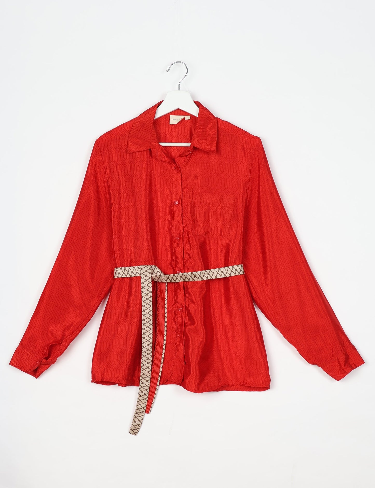 Experience sustainable fashion with our classic slim-fit shirt, crafted with ethical and green values. The shirt, designed for minimal waste, features a tie-up waist belt or neck tie, semi-spread collar, and regular shirt cuffs. Versatile and eco-friendly, wear it tucked in, unbuttoned over a tank top, or knotted at the waist for a unique style.