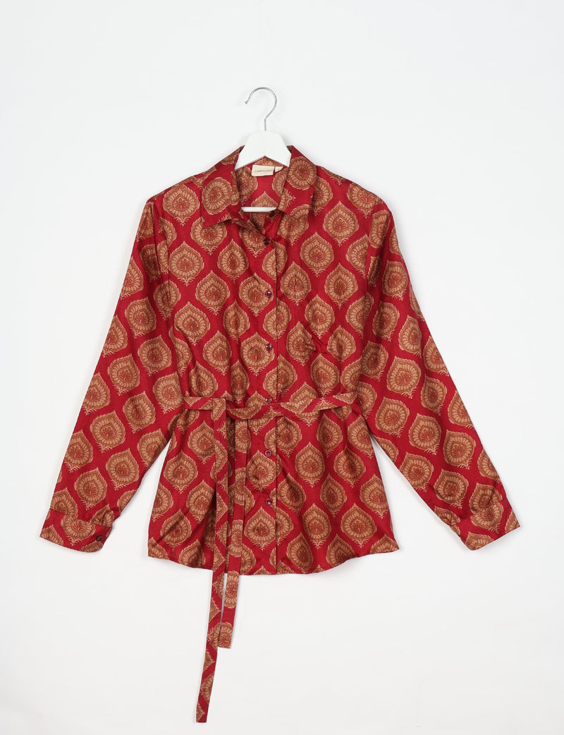 Red long-sleeve button-up shirt with brown leaf pattern and waist tie, displayed on white hanger against white background