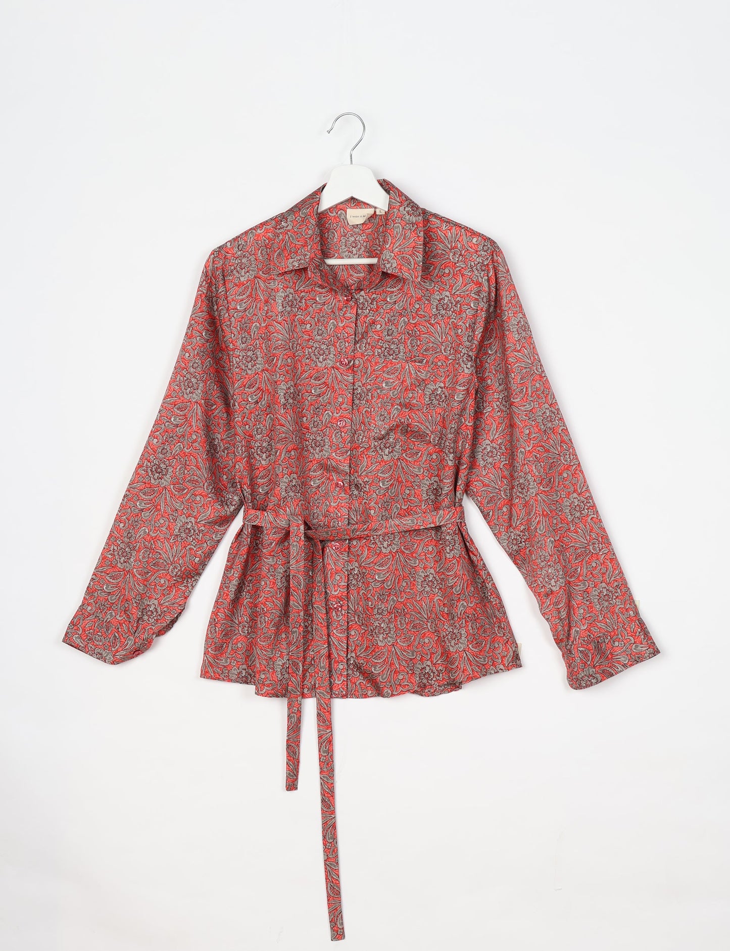 Experience sustainable fashion with our classic slim-fit shirt, crafted with ethical and green values. The shirt, designed for minimal waste, features a tie-up waist belt or neck tie, semi-spread collar, and regular shirt cuffs. Versatile and eco-friendly, wear it tucked in, unbuttoned over a tank top, or knotted at the waist for a unique style.