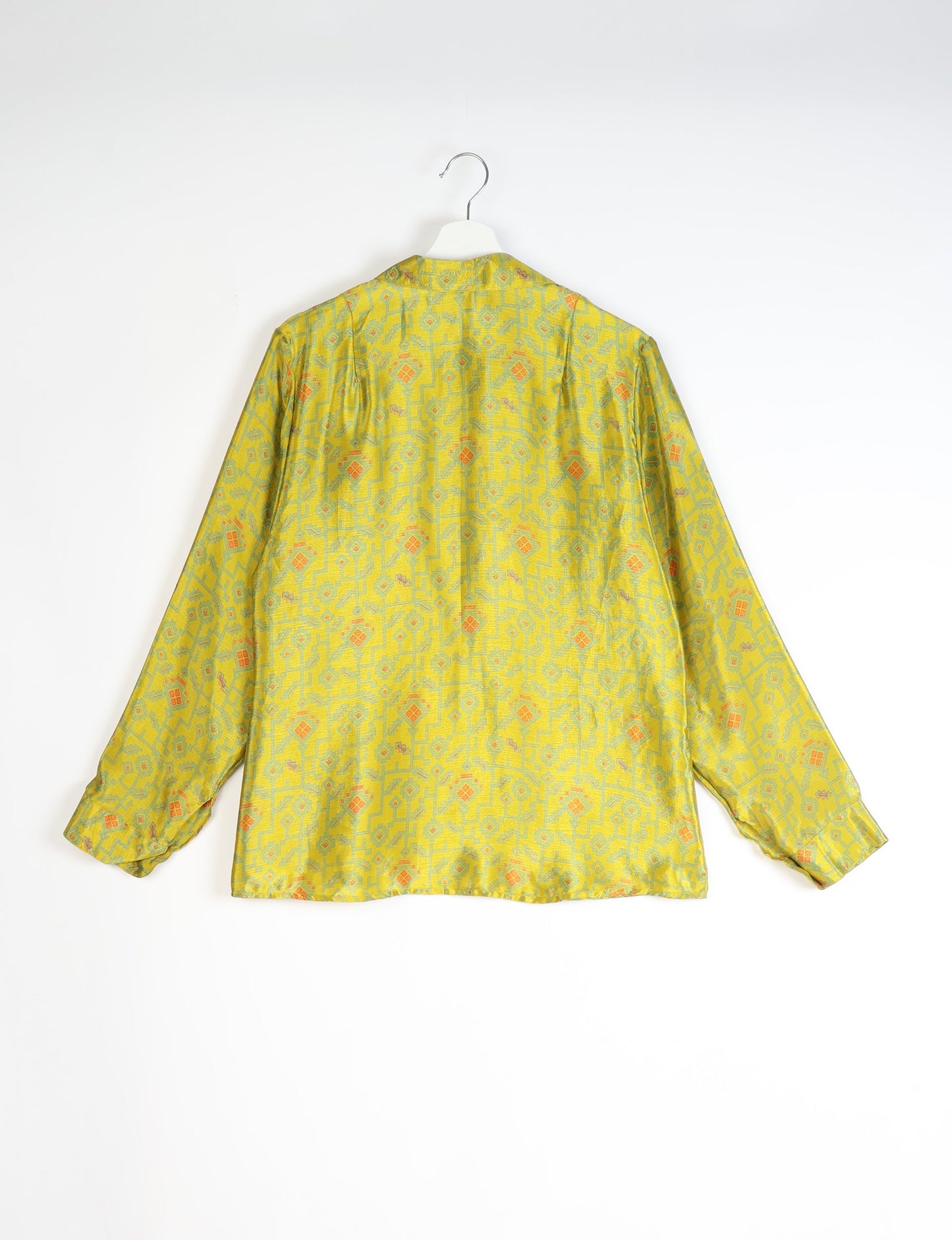 Experience sustainable fashion with our classic slim-fit shirt, crafted with ethical and green values. The shirt, designed for minimal waste, features a tie-up waist belt or neck tie, semi-spread collar, and regular shirt cuffs. Versatile and eco-friendly, wear it tucked in, unbuttoned over a tank top, or knotted at the waist for a unique style.