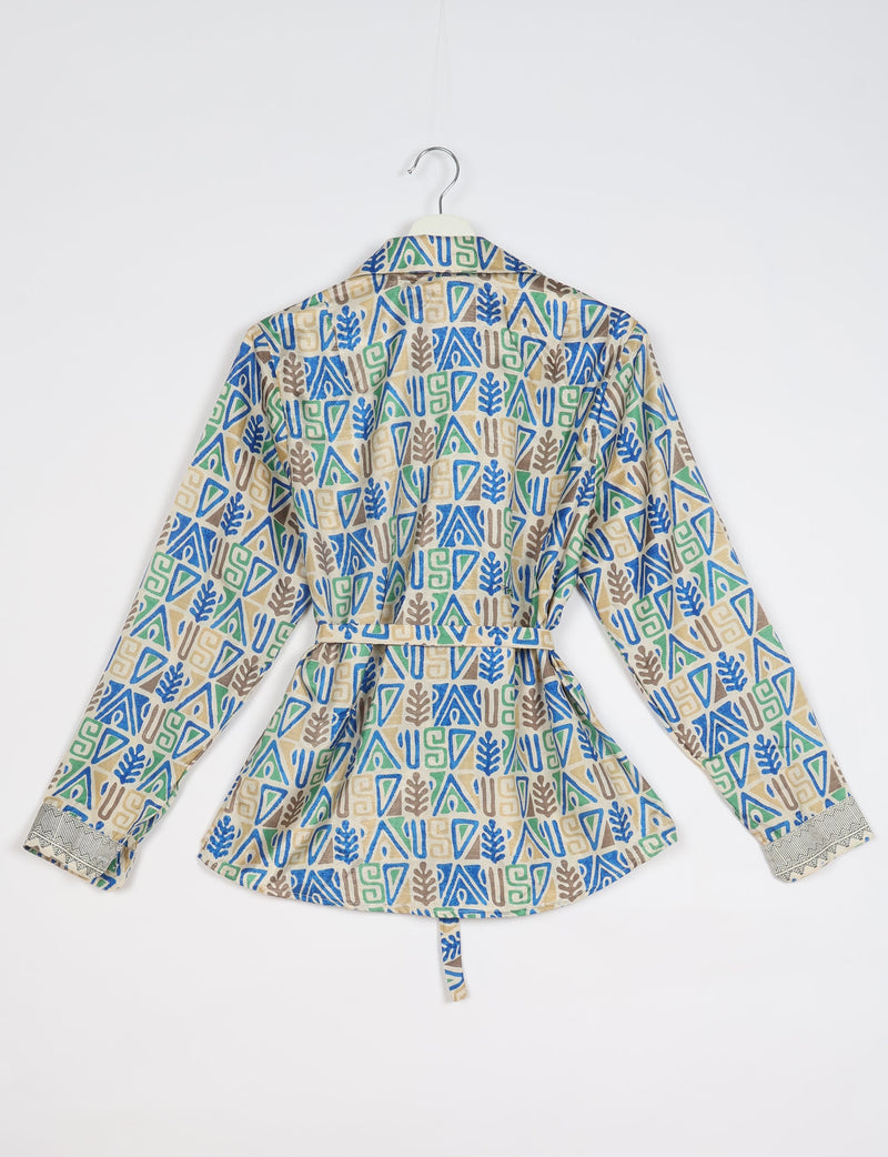 Long-sleeve shirt with blue, green, and brown geometric and leaf patterns, back view, hanging on white hanger