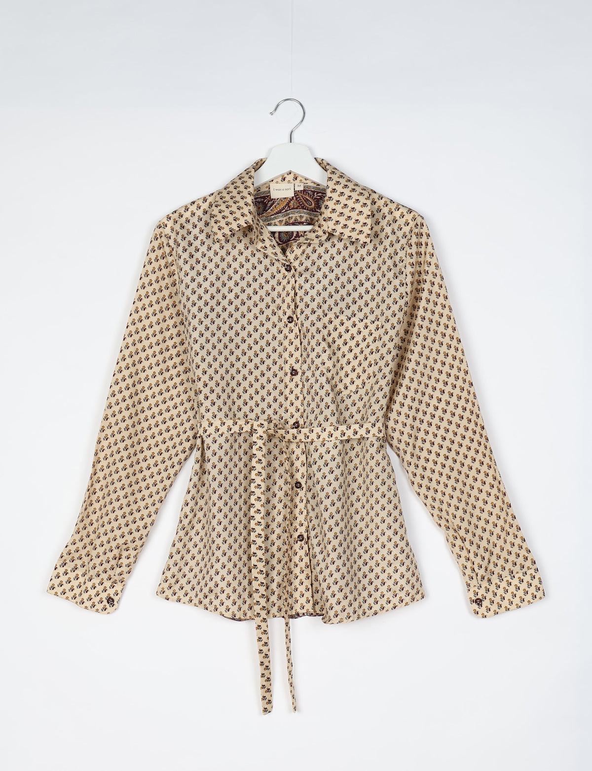 Experience sustainable fashion with our classic slim-fit shirt, crafted with ethical and green values. The shirt, designed for minimal waste, features a tie-up waist belt or neck tie, semi-spread collar, and regular shirt cuffs. Versatile and eco-friendly, wear it tucked in, unbuttoned over a tank top, or knotted at the waist for a unique style.
