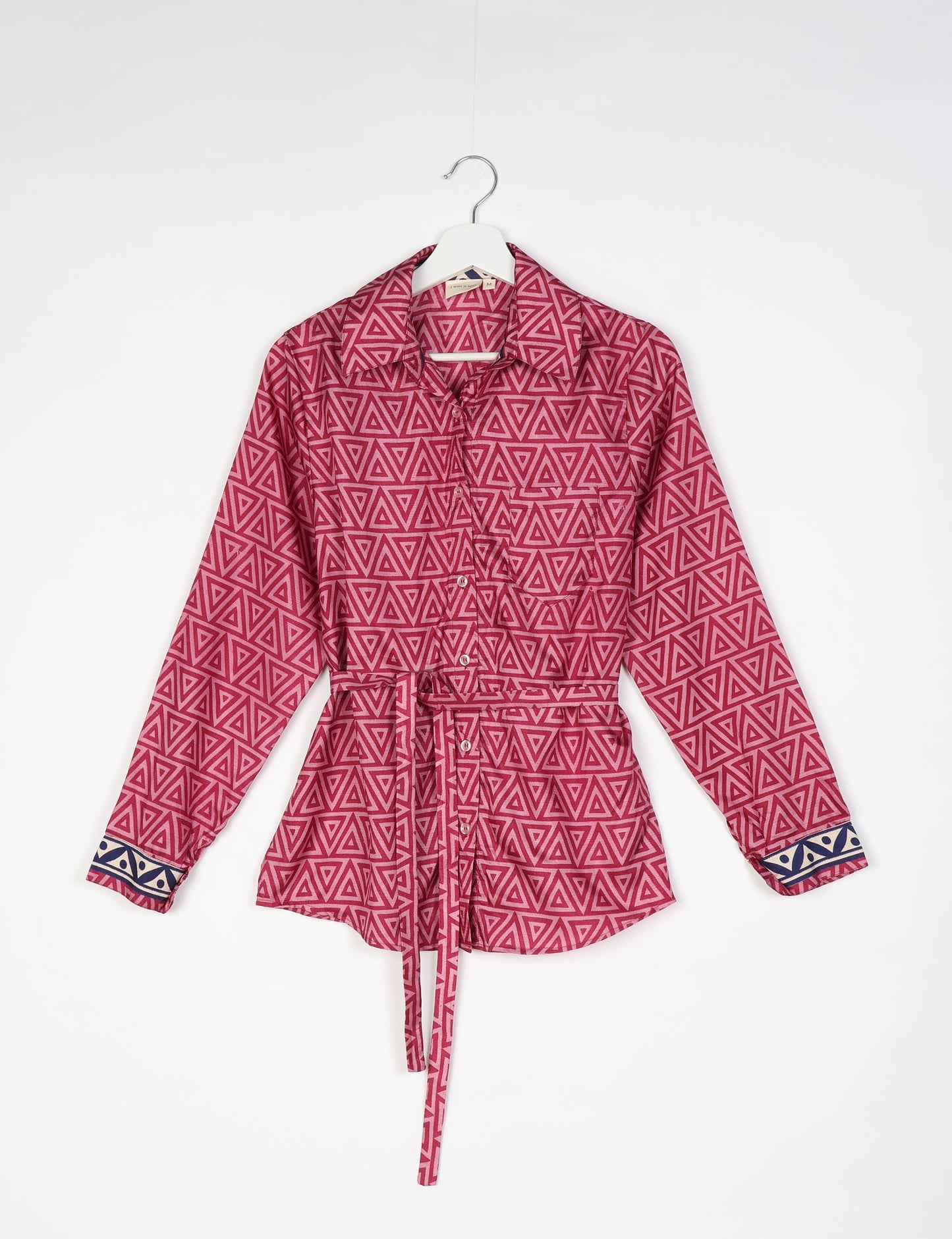 Experience sustainable fashion with our classic slim-fit shirt, crafted with ethical and green values. The shirt, designed for minimal waste, features a tie-up waist belt or neck tie, semi-spread collar, and regular shirt cuffs. Versatile and eco-friendly, wear it tucked in, unbuttoned over a tank top, or knotted at the waist for a unique style.