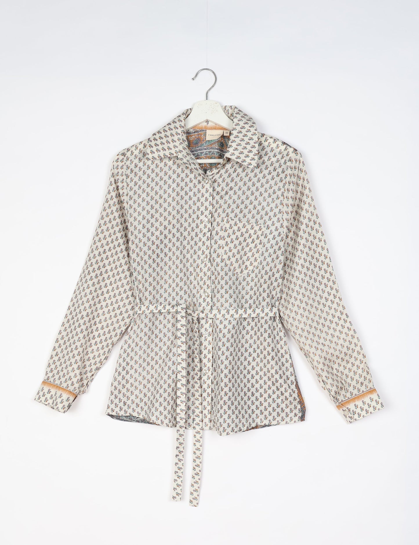 Experience sustainable fashion with our classic slim-fit shirt, crafted with ethical and green values. The shirt, designed for minimal waste, features a tie-up waist belt or neck tie, semi-spread collar, and regular shirt cuffs. Versatile and eco-friendly, wear it tucked in, unbuttoned over a tank top, or knotted at the waist for a unique style.