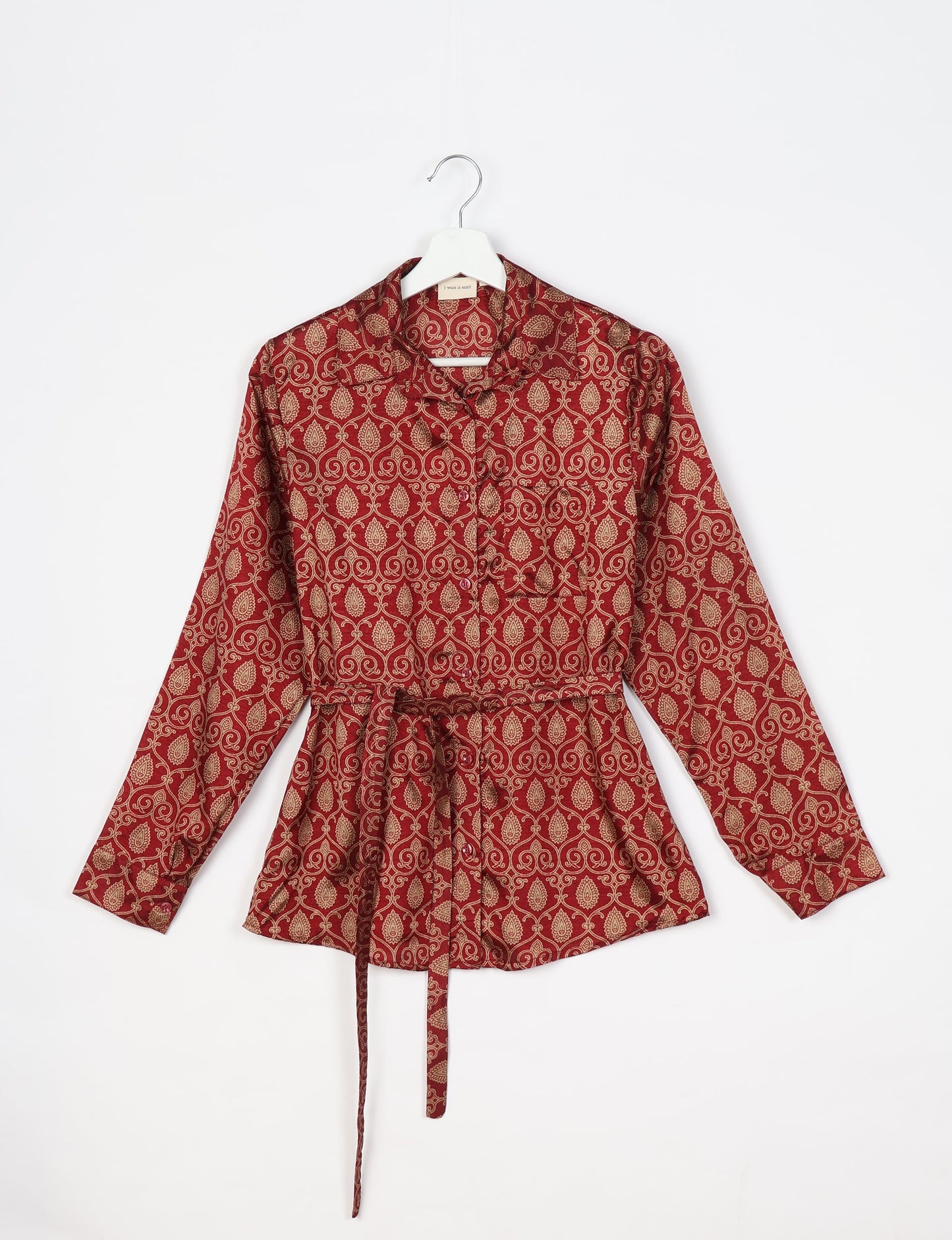 Experience sustainable fashion with our classic slim-fit shirt, crafted with ethical and green values. The shirt, designed for minimal waste, features a tie-up waist belt or neck tie, semi-spread collar, and regular shirt cuffs. Versatile and eco-friendly, wear it tucked in, unbuttoned over a tank top, or knotted at the waist for a unique style.