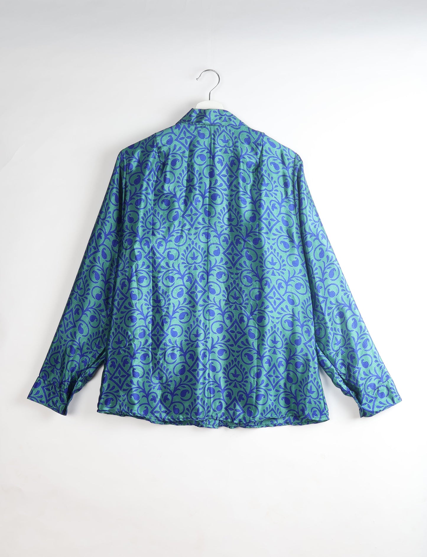 Experience sustainable fashion with our classic slim-fit shirt, crafted with ethical and green values. The shirt, designed for minimal waste, features a tie-up waist belt or neck tie, semi-spread collar, and regular shirt cuffs. Versatile and eco-friendly, wear it tucked in, unbuttoned over a tank top, or knotted at the waist for a unique style.