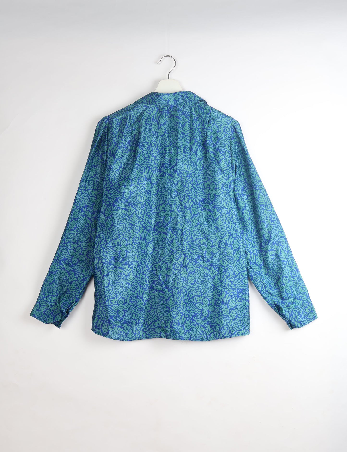 Experience sustainable fashion with our classic slim-fit shirt, crafted with ethical and green values. The shirt, designed for minimal waste, features a tie-up waist belt or neck tie, semi-spread collar, and regular shirt cuffs. Versatile and eco-friendly, wear it tucked in, unbuttoned over a tank top, or knotted at the waist for a unique style.