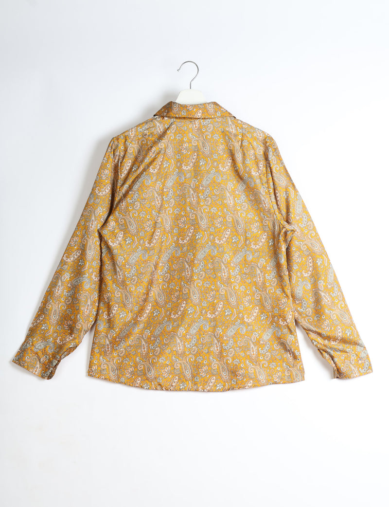 Yellow paisley long-sleeve shirt with collar, buttoned cuffs, shown from back on white hanger against white background