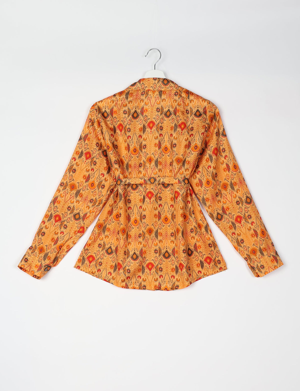 Orange ethnic patterned long-sleeve shirt with collar and belt detail, shown from back on white hanger against white background