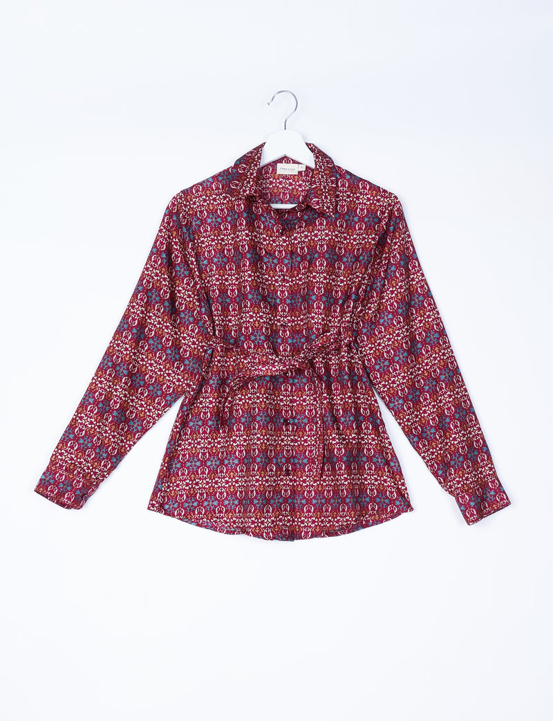 Brown and red Indian ethnic patterned long-sleeve shirt with collar and waist tie, hanging on white hanger, front view