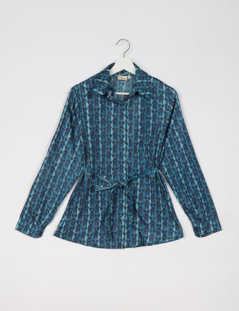 Blue Indian ethnic shirt with long sleeves, button front, collar, and waist tie, hanging on a white hanger