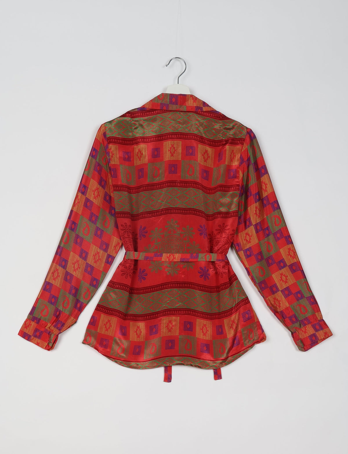Red ethnic shirt with green, purple, and gold geometric and floral patterns, long sleeves, and a back belt, shown from rear