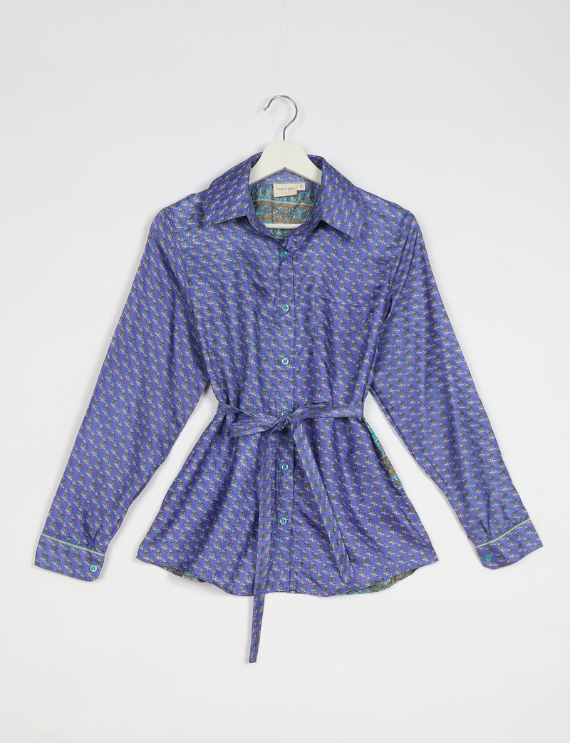 Blue Indian ethnic long-sleeve shirt with small floral pattern, button front, collar, and waist tie, hanging on white hanger