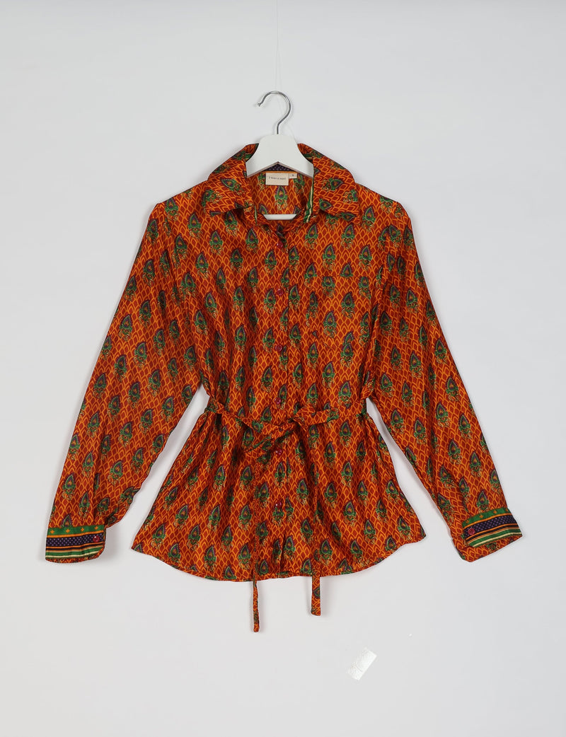 Orange long-sleeve shirt with green and blue floral micro design, button front, collar, and tie waist, hanging on white hanger