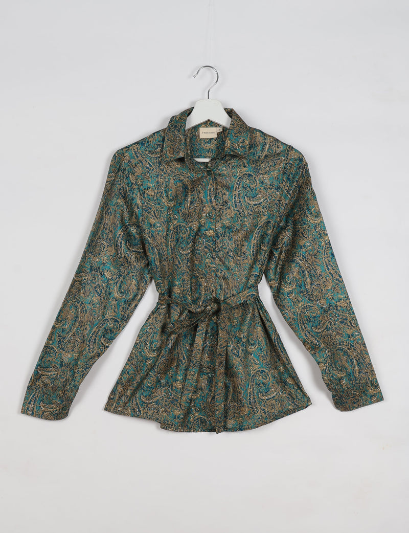 Green paisley long-sleeve button-up shirt with collar and waist tie, hanging on white hanger against white background