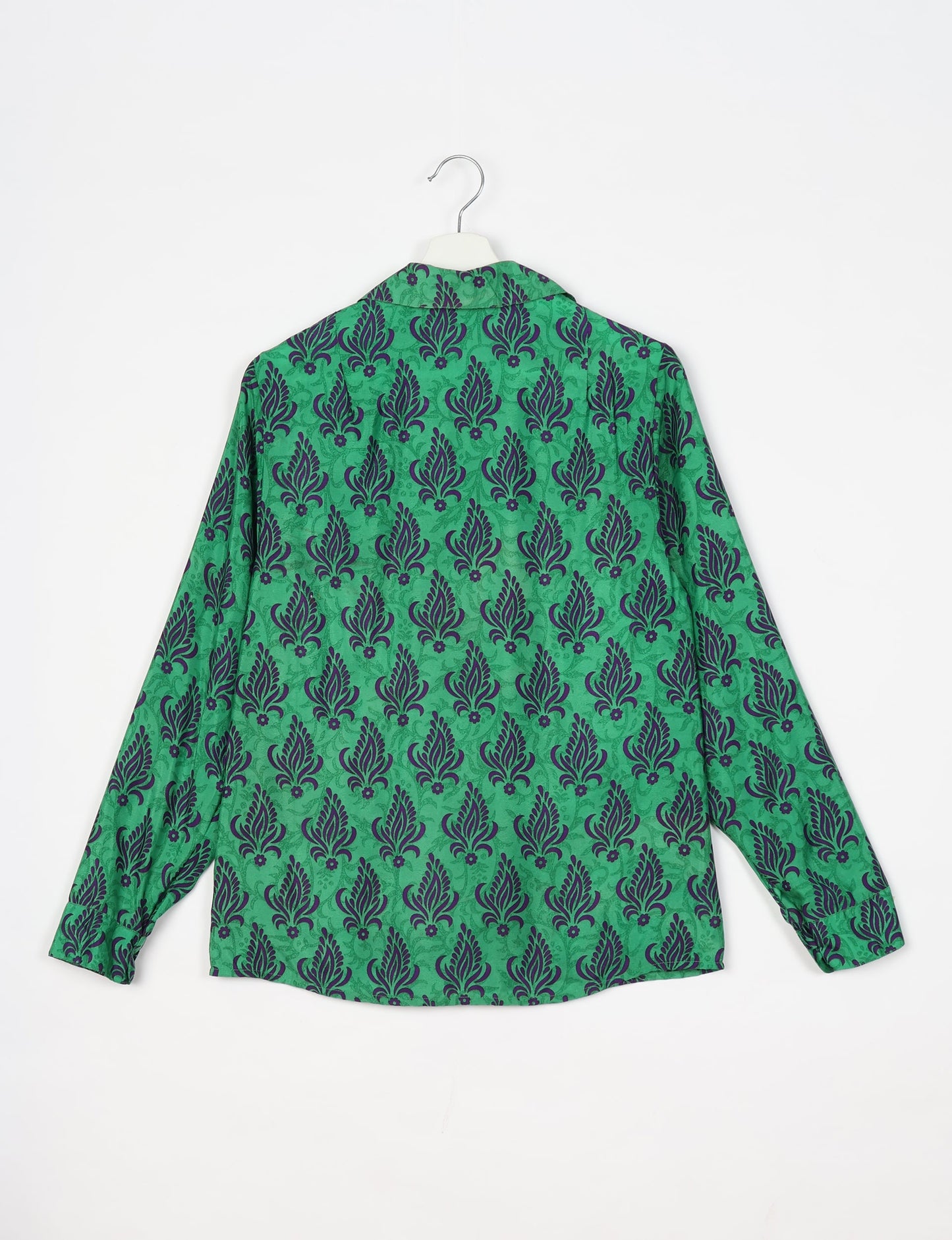 Experience sustainable fashion with our classic slim-fit shirt, crafted with ethical and green values. The shirt, designed for minimal waste, features a tie-up waist belt or neck tie, semi-spread collar, and regular shirt cuffs. Versatile and eco-friendly, wear it tucked in, unbuttoned over a tank top, or knotted at the waist for a unique style.