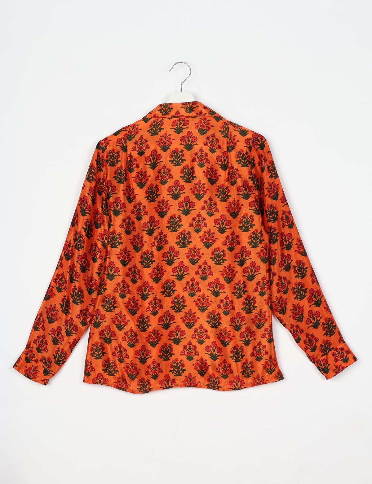 Orange long-sleeve shirt with red and dark green floral pattern, shown from back on white hanger against white background