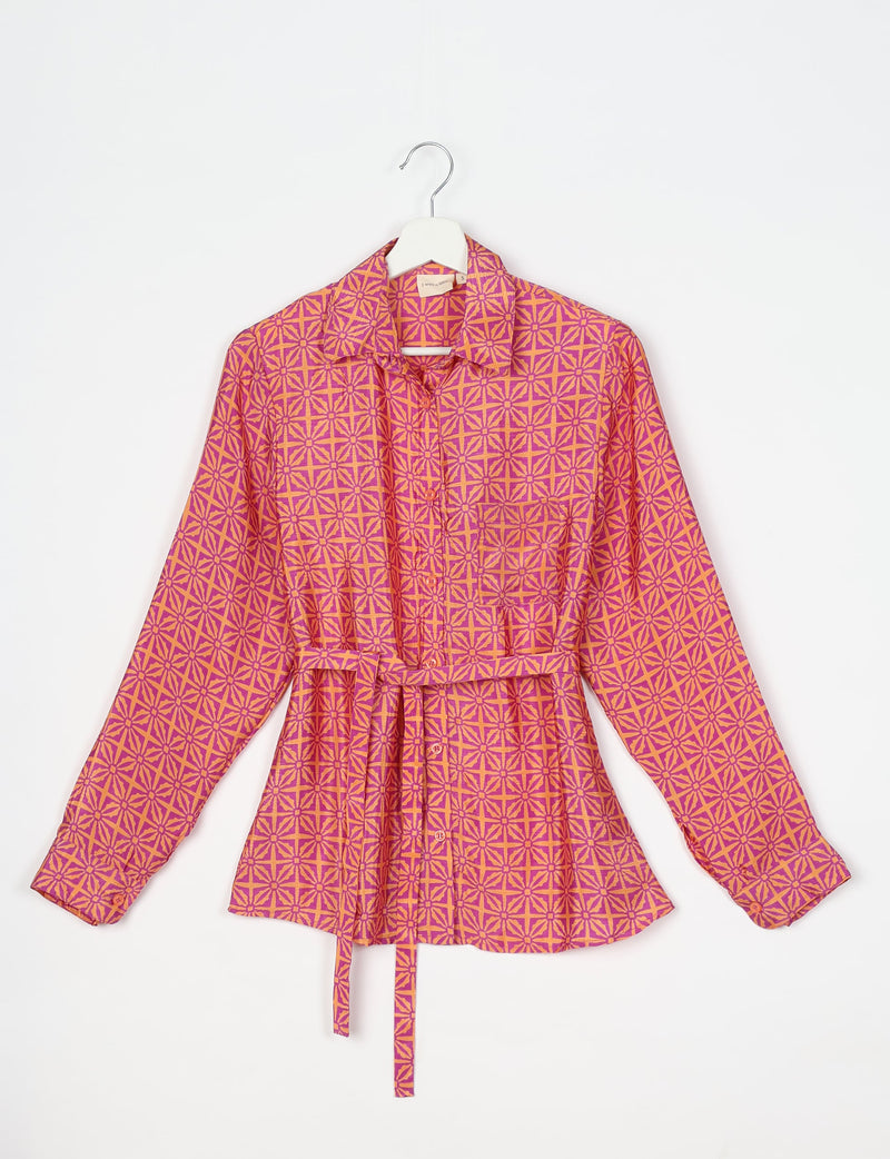Pink and orange geometric patterned long-sleeve shirt with collar, button front, and waist tie, hanging on white hanger