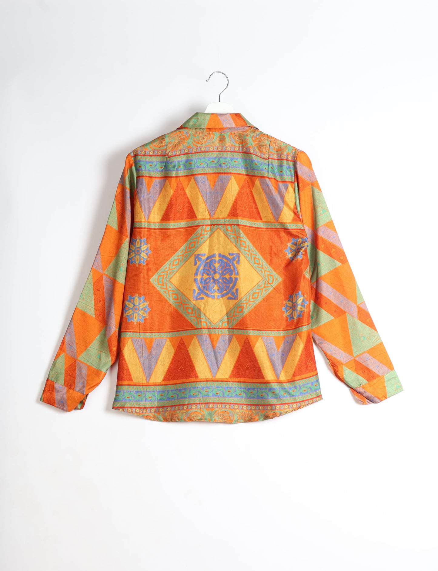 Experience sustainable fashion with our classic slim-fit shirt, crafted with ethical and green values. The shirt, designed for minimal waste, features a tie-up waist belt or neck tie, semi-spread collar, and regular shirt cuffs. Versatile and eco-friendly, wear it tucked in, unbuttoned over a tank top, or knotted at the waist for a unique style.