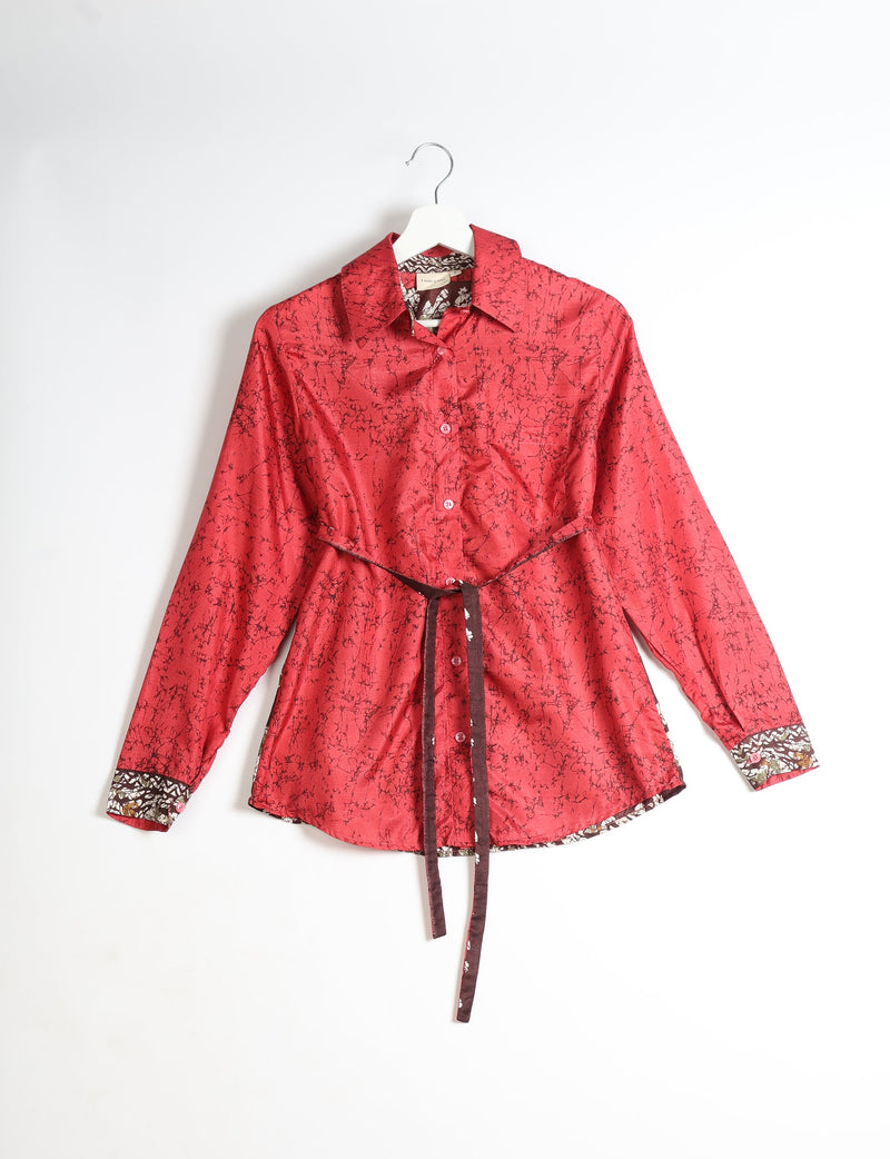 Red long-sleeve button-up shirt with black abstract pattern, floral inner collar and cuffs, and brown waist tie, on hanger