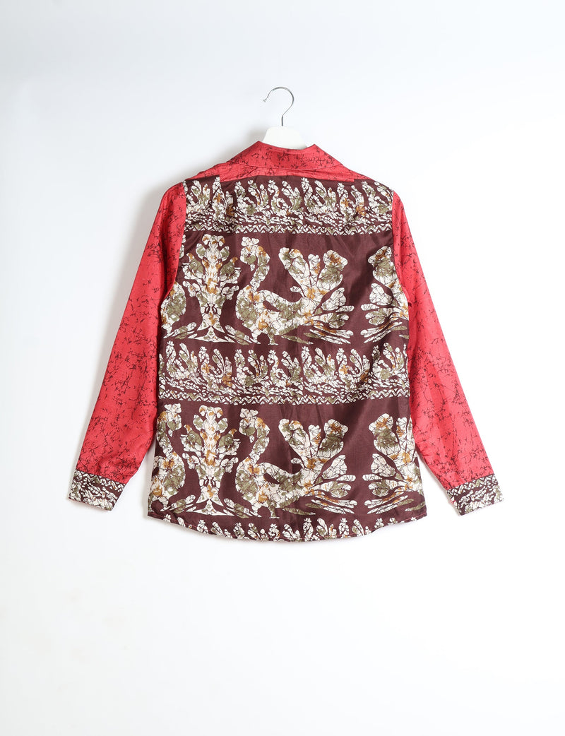 Red long-sleeve shirt with abstract floral pattern on back and cuffs, shown hanging from a white hanger