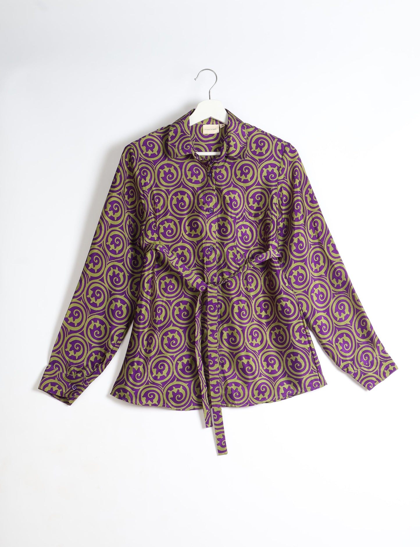 Experience sustainable fashion with our classic slim-fit shirt, crafted with ethical and green values. The shirt, designed for minimal waste, features a tie-up waist belt or neck tie, semi-spread collar, and regular shirt cuffs. Versatile and eco-friendly, wear it tucked in, unbuttoned over a tank top, or knotted at the waist for a unique style.