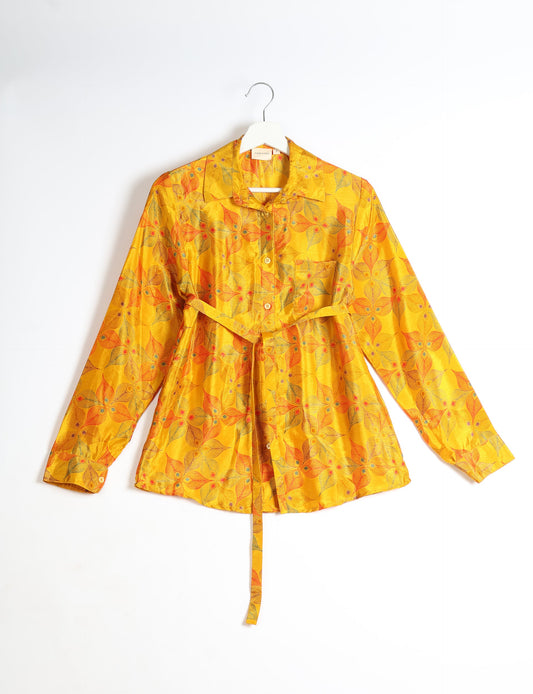 Experience sustainable fashion with our classic slim-fit shirt, crafted with ethical and green values. The shirt, designed for minimal waste, features a tie-up waist belt or neck tie, semi-spread collar, and regular shirt cuffs. Versatile and eco-friendly, wear it tucked in, unbuttoned over a tank top, or knotted at the waist for a unique style.