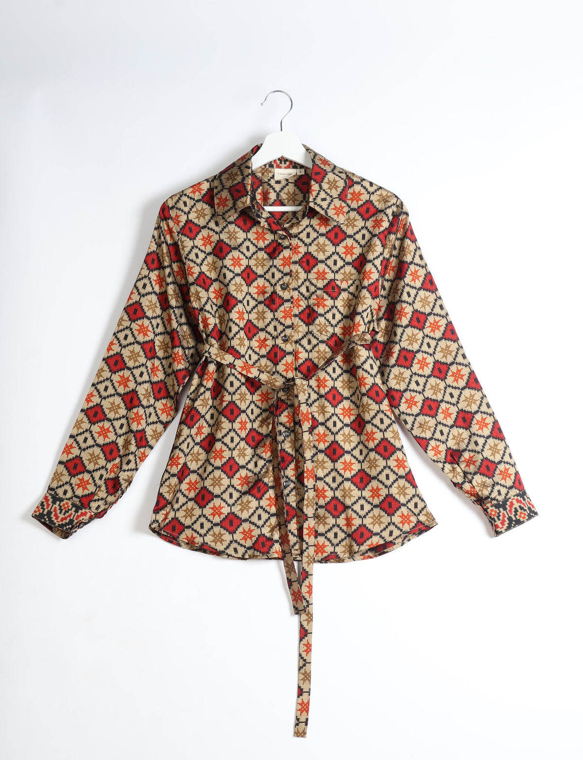 Beige geometric patterned long-sleeve shirt with collar and front buttons, displayed on a white hanger