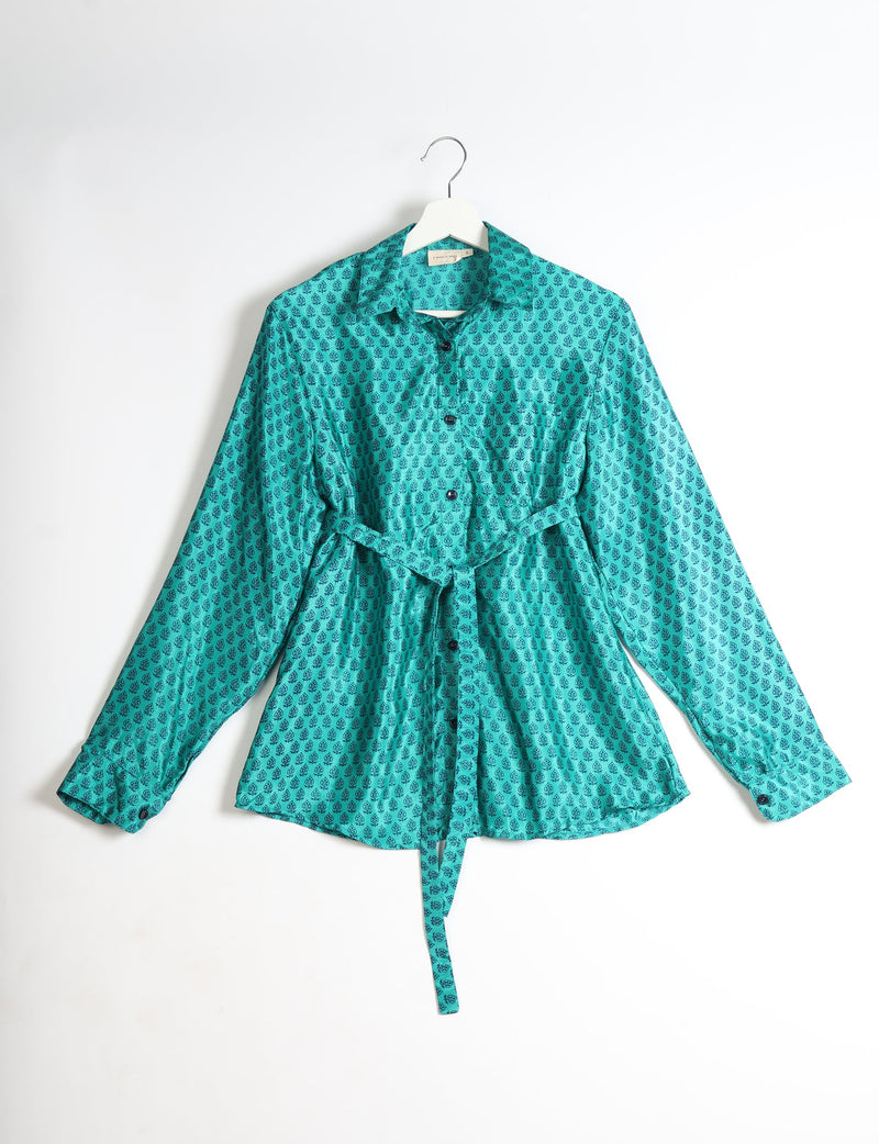 Teal long-sleeve shirt with black micro floral pattern, button front, collar, and waist tie, hanging on white hanger