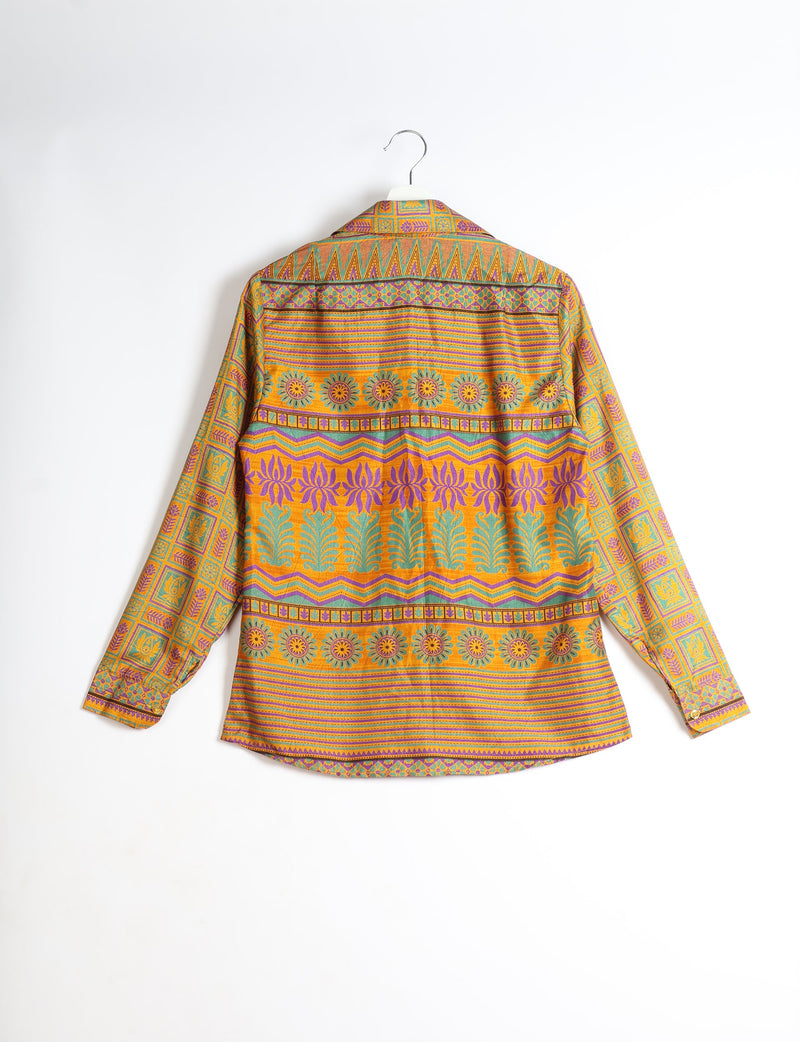 Long-sleeve yellow shirt with multicolor geometric and floral patterns, shown from back on a hanger against white background