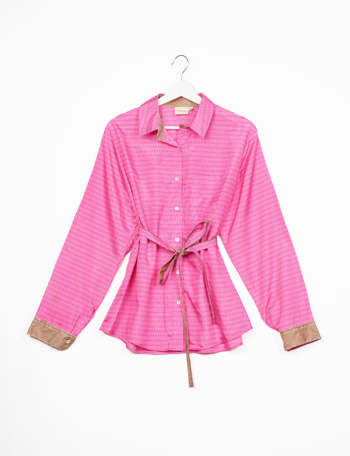 Experience sustainable fashion with our classic slim-fit shirt, crafted with ethical and green values. The shirt, designed for minimal waste, features a tie-up waist belt or neck tie, semi-spread collar, and regular shirt cuffs. Versatile and eco-friendly, wear it tucked in, unbuttoned over a tank top, or knotted at the waist for a unique style.