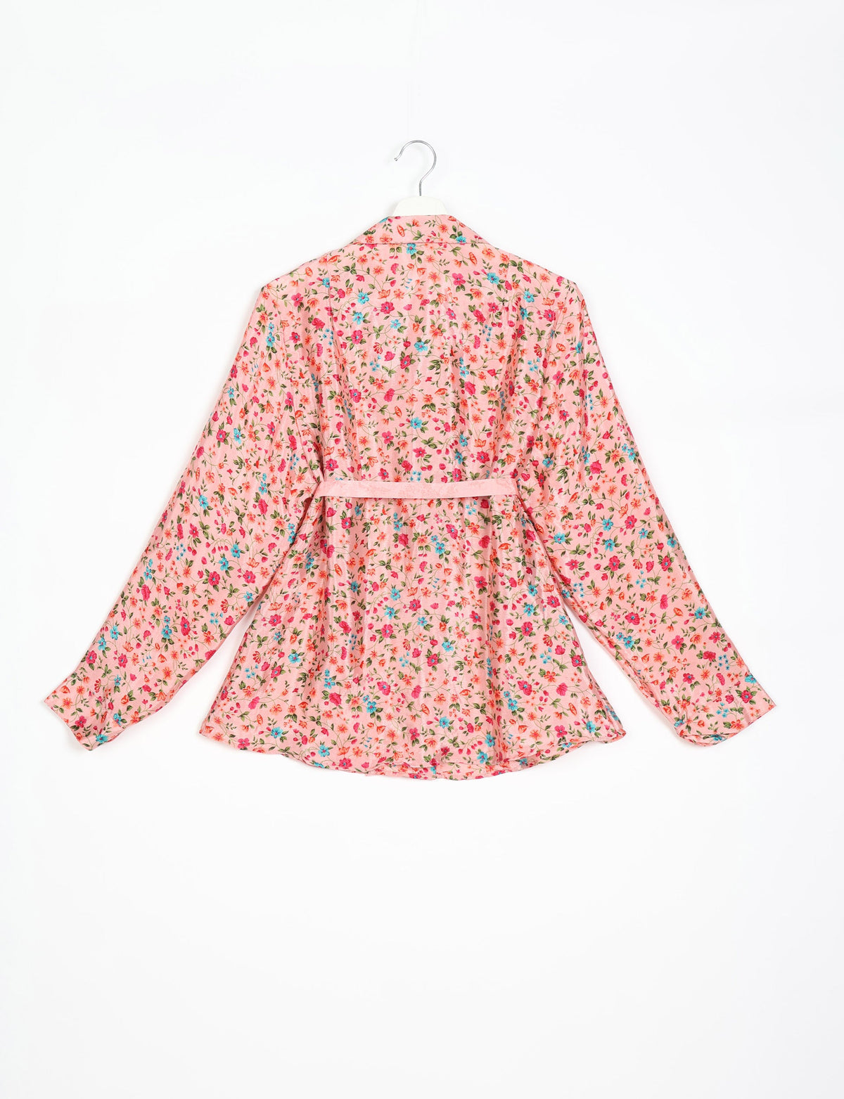 Pink tropical floral shirt with long sleeves and belt, shown from the back on a hanger against white background