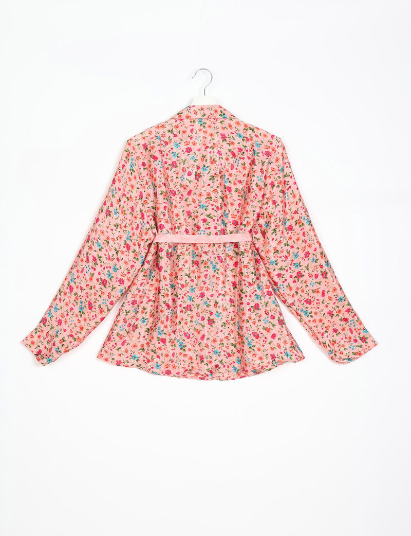 Pink tropical floral shirt with long sleeves and belt, shown from the back on a hanger against white background